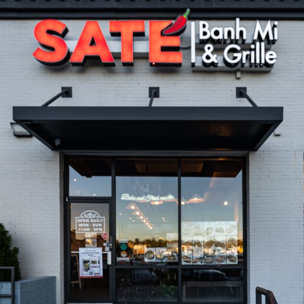 Exterior of SATE Banh Mi & Grille, with a red chili pepper in the neon sign.