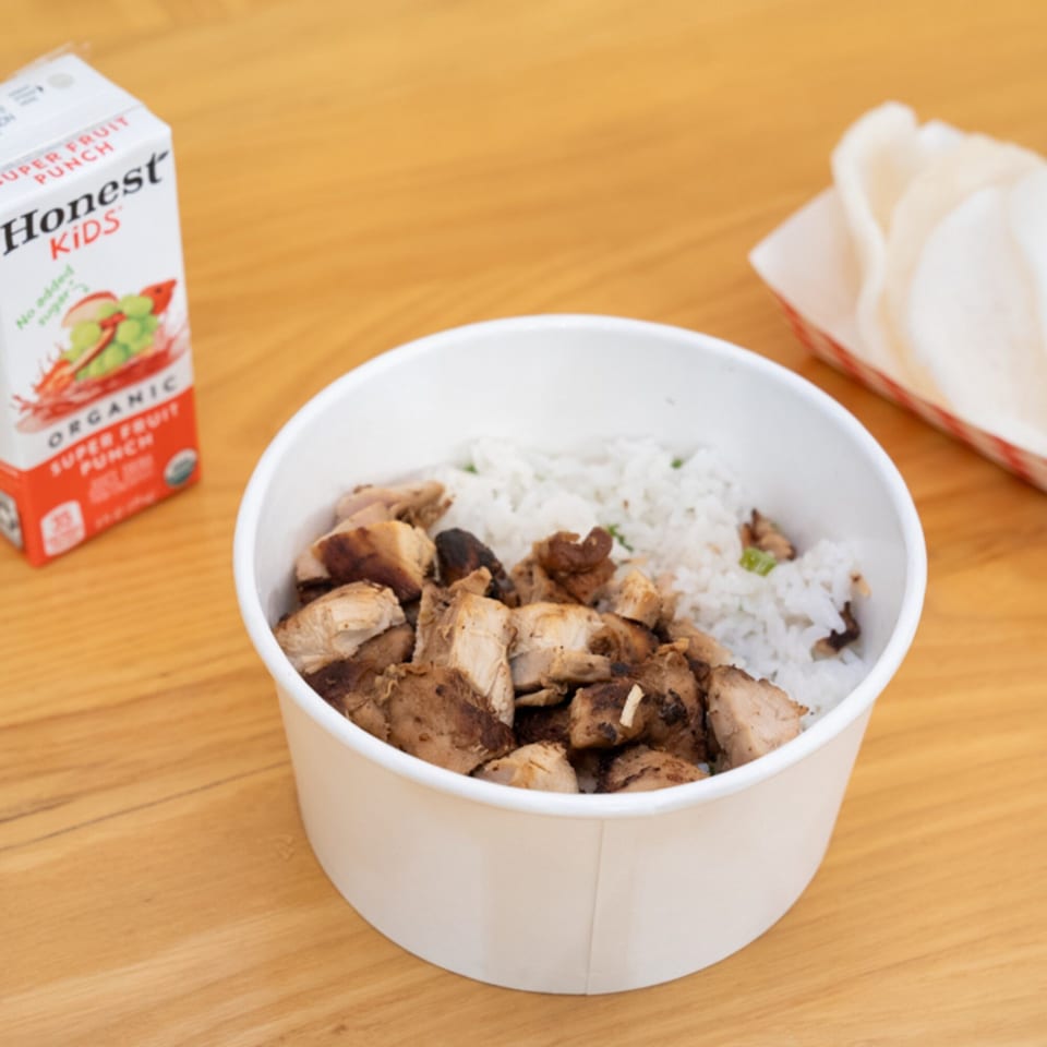 A SATE Banh Mi & Grille rice bowl with grilled chicken, a juice box, and shrimp chips.