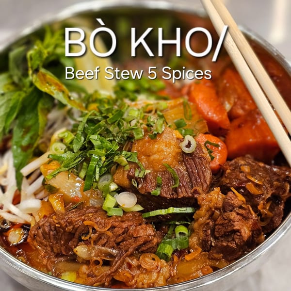 Close-up of SATE Banh Mi & Grille's Bo Kho, a Vietnamese beef stew with carrots and herbs.