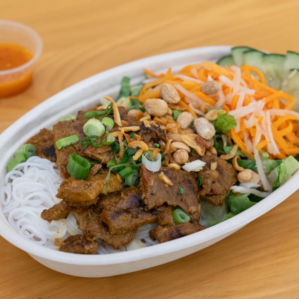 Vietnamese vermicelli bowl with grilled meat, peanuts, fried onions, and pickled vegetables.