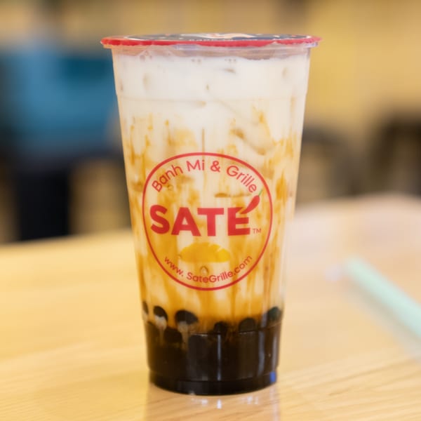 A SATE Banh Mi & Grille bubble tea with milk, brown sugar swirls, and tapioca pearls.