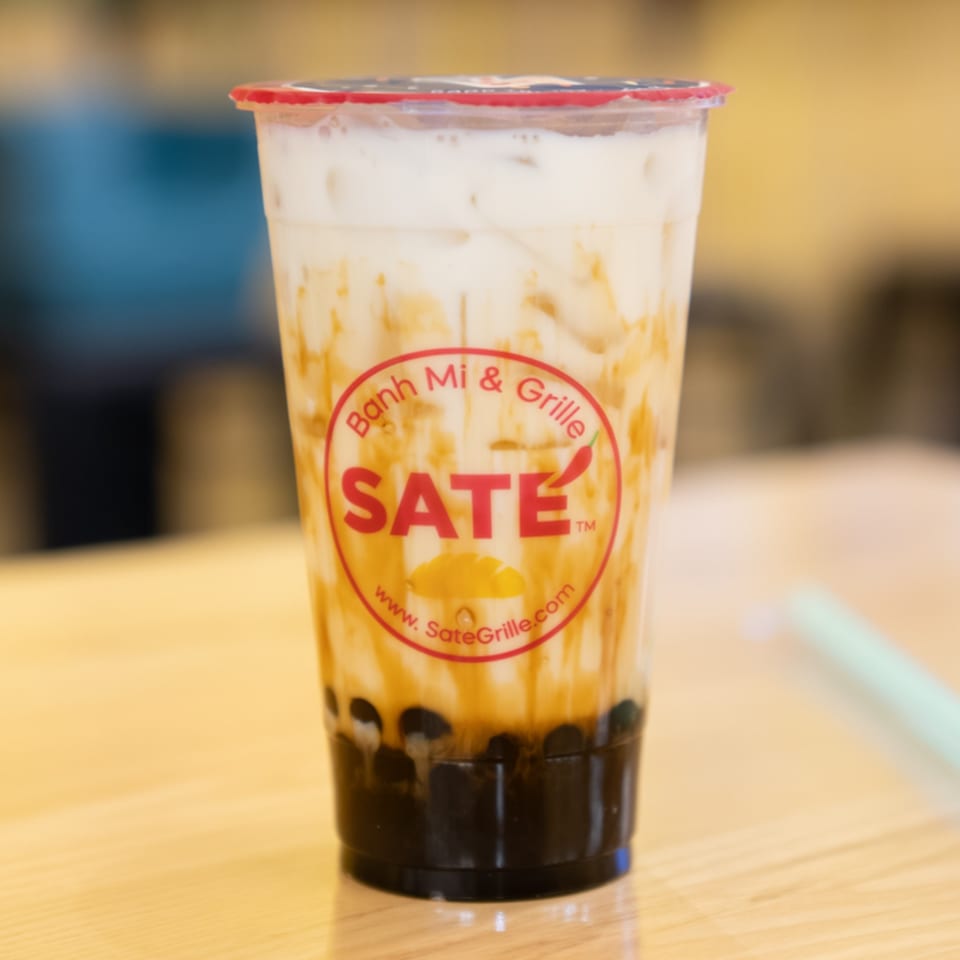 A SATE Banh Mi & Grille bubble tea with milk, brown sugar swirls, and tapioca pearls.